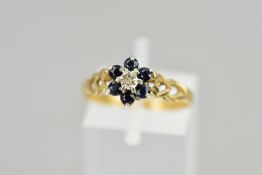 A 9CT GOLD SAPPHIRE AND DIAMOND CLUSTER RING, the central single cut diamond in an illusion