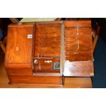 A VICTORIAN WALNUT SLOPED TWO DOOR STATIONARY CABINET, the interior revealing two inkwells and a