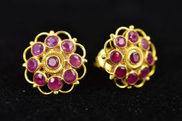 A PAIR OF RUBY EARRING STUDS, the central circular ruby within a spiral twist border and circular