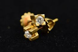 A PAIR OF DIAMOND STUD EARRINGS, each designed as a brilliant cut diamond within a chunky four