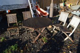 A TEAK GARDEN TABLE and four folding chairs (5)