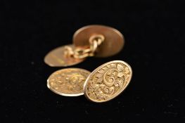 AN EDWARDIAN PAIR OF OVAL CUFFLINKS fully engraved in a foliate design, chain link connectors,