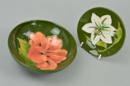 TWO PIECES MOORCROFT POTTERY, to include a small footed bowl 'Hibiscus' pattern on green ground,
