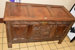 A LATE 19TH CENTURY CARVED OAK TRIPLE PANEL COFFER, the front with central panel depicting arrest of