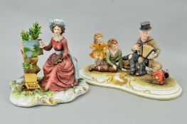 A CAPODIMONTE FIGURE GROUP, signed by Merli, of an organ player with monkey and seated children,