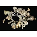 A MID TO LATE 20TH CENTURY SILVER CHARM BRACELET, together with twenty two assorted charms to