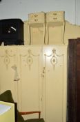 A CREAM AND GILT TWO PIECE BEDROOM SUITE comprising of a three door wardrobe, width 156cm x depth