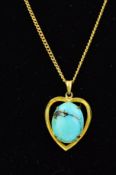 A GOLD PLATED TURQUOISE PENDANT, designed as an open heart shape pendant centrally set with an