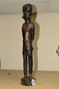 A WOODEN CHIP CARVED SCULPTURE OF AN AFRICAN SLAVE fitted with a mouth gag and chains to the wrists,