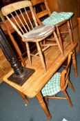 A PINE KITCHEN TABLE, two oak bar back chairs and a spindle back chair (4)