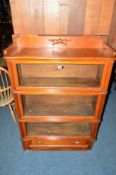 A REPRODUCTION MAHOGANY THREE SECTION BOOKCASE with glazed fall front doors and single drawer,