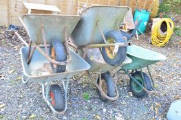 FOUR GALVANISED WHEEL BARROWS and a plastic wheel barrow (5)