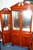 A YEWWOOD GLAZED TWO DOOR BOOKCASE with two drawers, together with a matching corner cupboard (