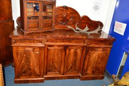 A VICTORIAN FLAME MAHOGANY SIDEBOARD with raised shaped back, three various drawers above four