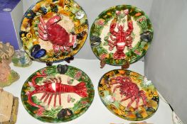 FOUR MAJOLICA PALISSY STYLE LOBSTER AND CRAB PLAQUES, with central crab or lobster surrounded by