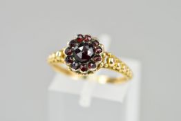 A VICTORIAN GARNET RING, a round cluster of rose cut Bohemian garnets, fancy applied bead work