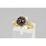 A VICTORIAN GARNET RING, a round cluster of rose cut Bohemian garnets, fancy applied bead work