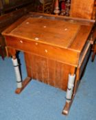 AN EARLY 20TH CENTURY LEDGER DESK with a hinged top, drop down flaps at each end and double cupboard