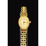 A LADY'S 9CT GOLD ACCURIST WATCH, the oval face with baton hour markers and single diamond set to