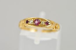 AN EDWARDIAN 18CT GOLD GARNET AND DIAMOND RING, the central circular garnet flanked by single cut