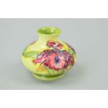 A SMALL MOORCROFT POTTERY SQUAT VASE, 'Orchid' pattern on yellow ground, impressed marks to base,