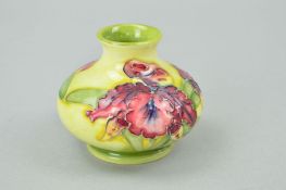 A SMALL MOORCROFT POTTERY SQUAT VASE, 'Orchid' pattern on yellow ground, impressed marks to base,