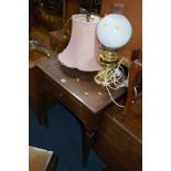 A SINGER OAK CASED TREADLE SEWING MACHINE and two table lamps (3)
