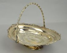 A SILVER PLATED WALKER AND HALL BASKET WITH HINGED HANDLE, of oval outline, the bowl engraved with