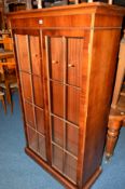 A YEWWOOD GLAZED TWO DOOR BOOKCASE width 95cm x depth 43cm x height 166cm, together with another