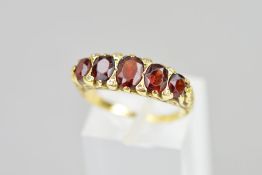 A LATE VICTORIAN 18CT GOLD FIVE STONE GARNET RING, designed as five graduated oval garnets with