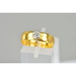 A VICTORIAN 22CT YELLOW GOLD BAND set with a single modern round brilliant cut diamond estimated