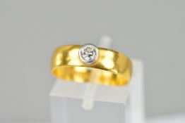 A VICTORIAN 22CT YELLOW GOLD BAND set with a single modern round brilliant cut diamond estimated