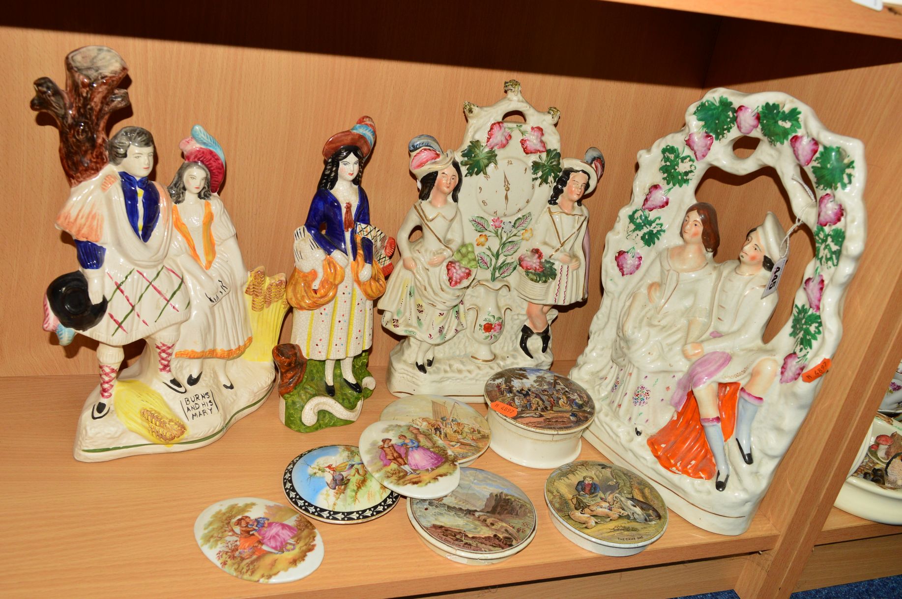 A GROUP OF STAFFORDSHIRE/STYLE FLATBACKS, POT LIDS etc, to include Arbour figure group, four pot