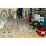 A QUANTITY OF CUT GLASS, etc, to include drinking glasses, decanters and vases, etc