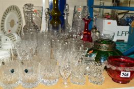 A QUANTITY OF CUT GLASS, etc, to include drinking glasses, decanters and vases, etc