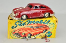 A BOXED GESCHA SIXMOBIL TINPLATE CLOCKWORK CAR, No.557, front overider loose but otherwise appears