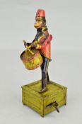 A GERMAN LITHOGRAPHED TINPLATE CLOCKWORK DRUMMING MONKEY FIGURE, wearing a lithographed red tunic