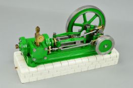 A HORIZONTAL SINGLE CYLINDER LIVE STEAM ENGINE, not tested, mounted on a re-painted brick effect