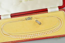 A DOUBLE ROW CULTURED PEARL NECKLACE AND A 14CT GOLD DIAMOND DRESS RING, the necklace designed as