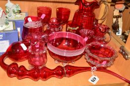 A GROUP OF CRANBERRY COLOURED GLASS ITEMS, to include jugs, bowls, pipe, approximate length 42cm,