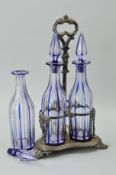 A TREFOIL SILVER PLATED DECANTER STAND with centre carry handle and three blue flashed glass