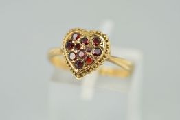 A GARNET RING, the head designed as a heart set with seven circular garnets with beaded edging,