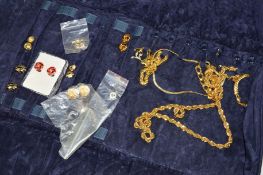 A JEWELLERY ROLL CONTAINING COSTUME JEWELLERY to include enamel ear clips, chain necklaces and