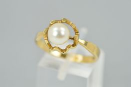 A 9CT GOLD CULTURED PEARL RING designed as a single cultured pearl a top a horizontal within an open