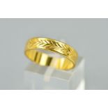 A 22CT GOLD BAND RING engraved to the centre band with a herringbone detail, hallmarked London 1967,