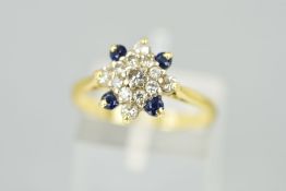 A SAPPHIRE AND DIAMOND DRESS RING, designed as a cluster of brilliant cut diamonds to the four outer