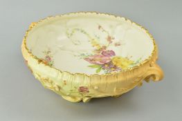 A ROYAL WORCESTER BLUSH IVORY TWIN HANDLED FOOTED BOWL, florally decorated, puce factory mark and