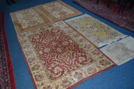 A MODERN RED GROUND RUG, 182cm x 122cm, a pair of red and gold rugs and two other rugs (5)