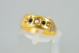 A LATE VICTORIAN 15CT GOLD GEM SET RING designed as a rectangular panel set with three split
