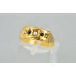 A LATE VICTORIAN 15CT GOLD GEM SET RING designed as a rectangular panel set with three split